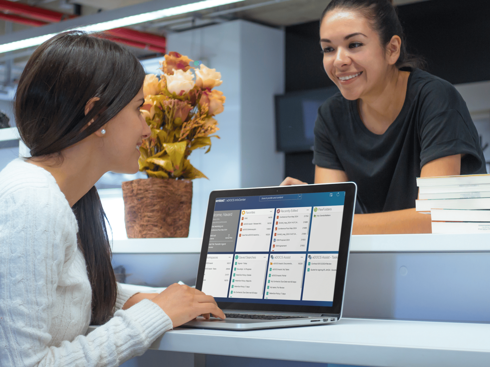macbook-mockup-of-two-ladies-at-the-library-with edocs infocenter on the screen